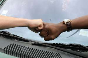 Trusting fist bump at car garage